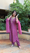 Close-up of mauve kurta neckline with gold thread embroidery