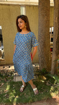 Model in blue handloom cotton calf-length kaftan dress with small buti block print and ghota patti trim, elbow sleeves