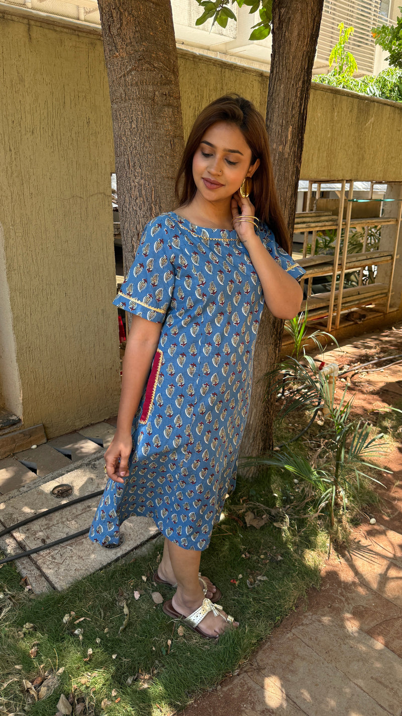 Three-quarter view of blue cotton kaftan dress showing relaxed fit