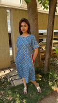 Close-up of ghota patti lace trim against blue block printed cotton
