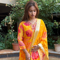 Detailed shot of the hand embroidery work near the neckline of the yellow organza kurta.
