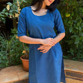 Full length portrait showcasing the complete royal blue cotton kurta set with flat sandals.