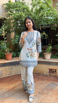Close-up of printed hem on matching ivory pants