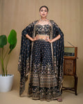 Front view of model wearing black floral printed modal cape set with wide-leg pants