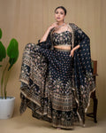 Close-up of hand embroidered bustier and lace trimmed cape border on black modal set