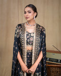 Close-up of lace trim along the edge of the black printed modal draped cape jacket