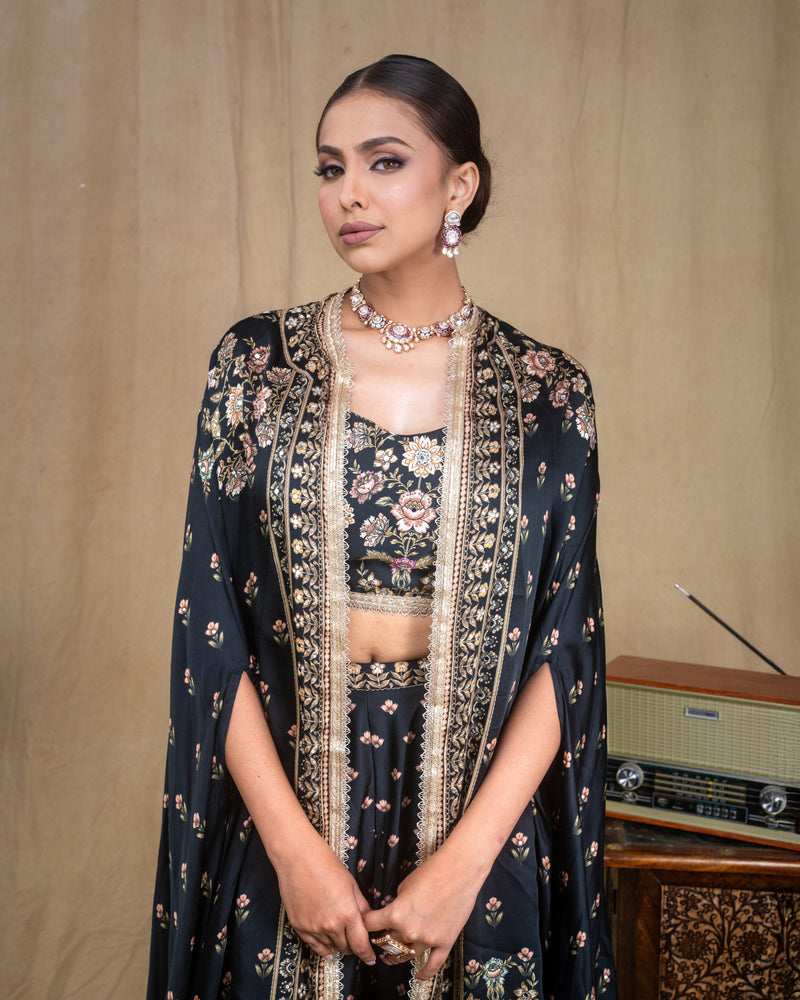 Close-up of lace trim along the edge of the black printed modal draped cape jacket