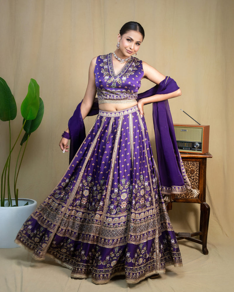 Detailed front view of deep purple embroidered skirt with metallic lace border panels