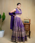 Model wearing deep purple modal lehenga set with fluid dupatta draped over arms