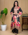Woman wearing a black floral printed modal Indo-Western dress with a mirror work yoke.