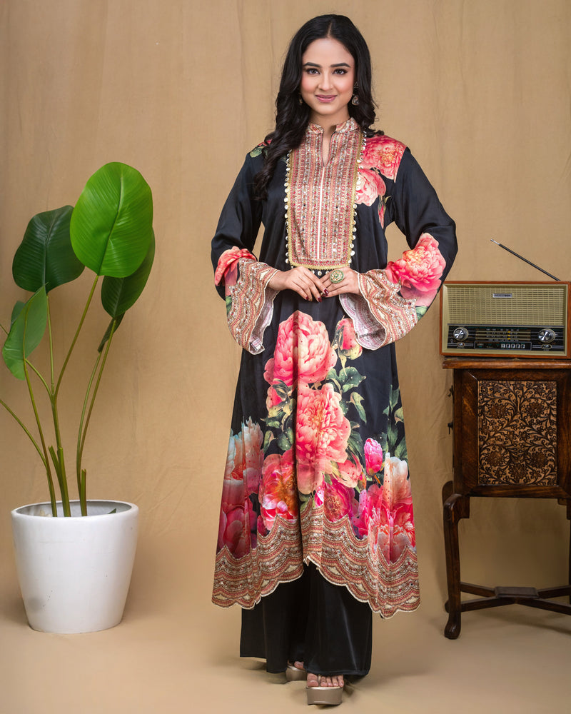 Woman wearing a black floral printed modal Indo-Western dress with a mirror work yoke.