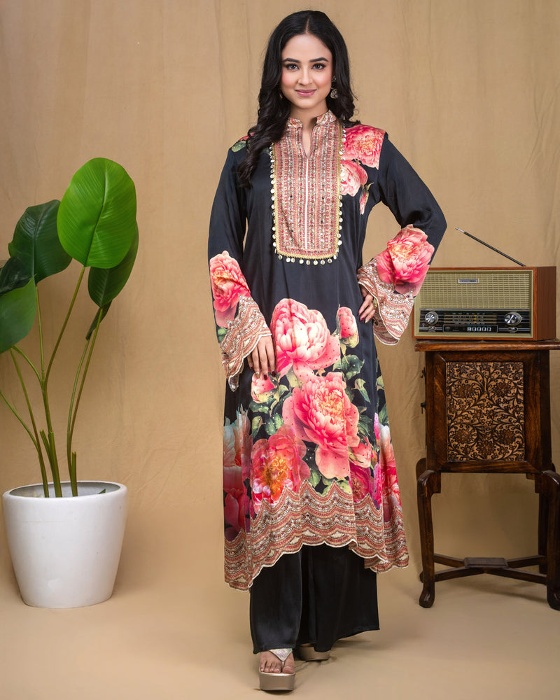 Close-up of hand embroidery, mirror work, and coin lace trim on black floral modal tunic.