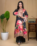 Detail of flared three-quarter sleeves with embroidered cuffs on black floral modal dress.