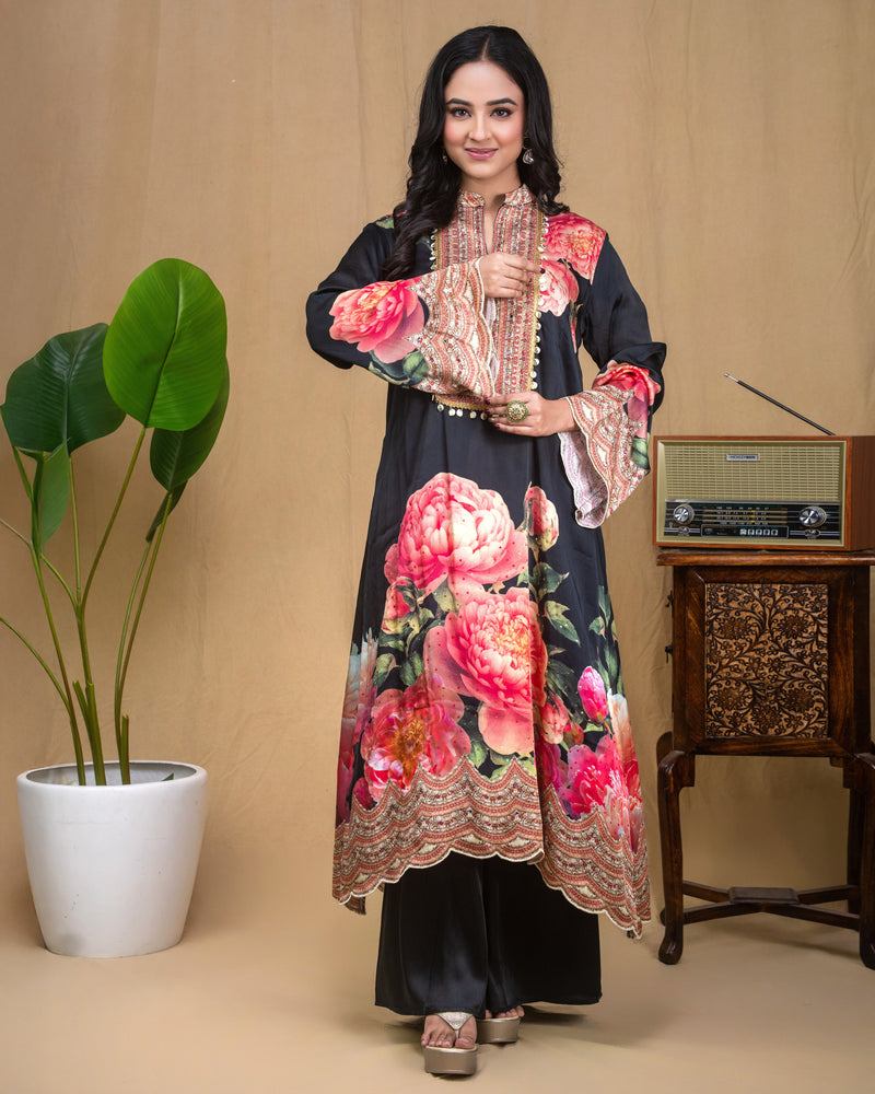 Detail of flared three-quarter sleeves with embroidered cuffs on black floral modal dress.
