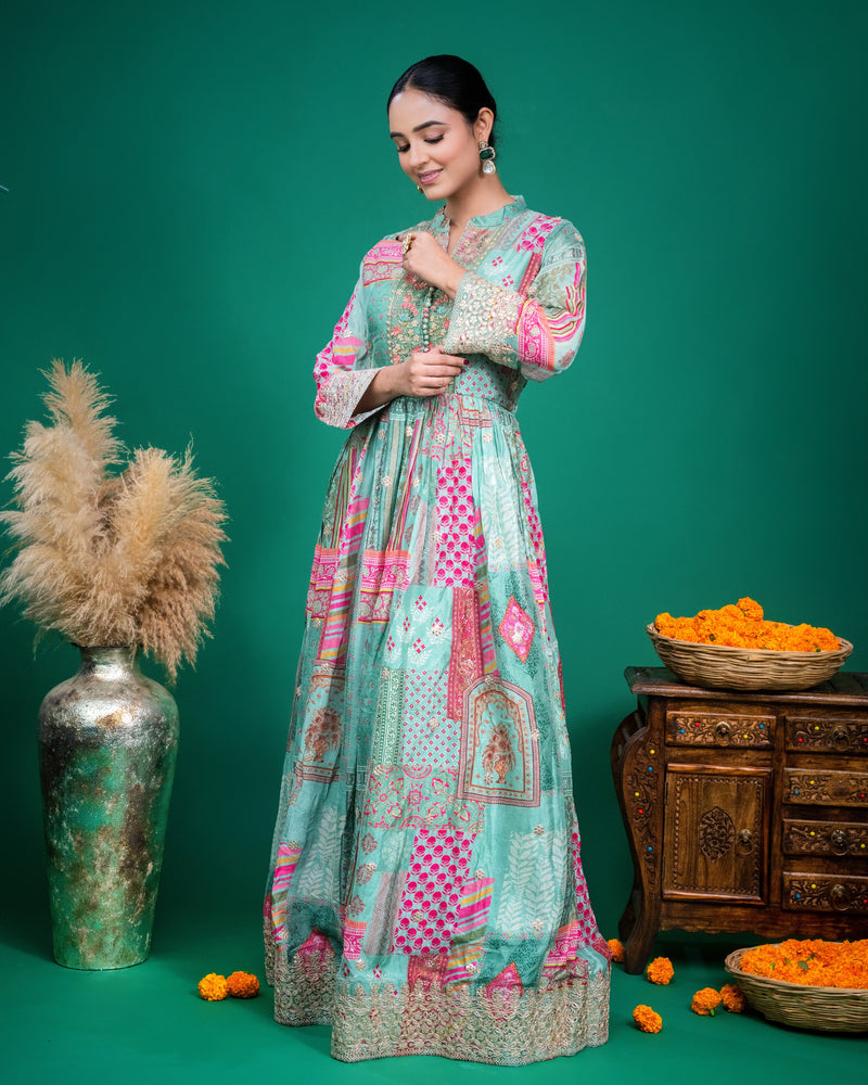 Side perspective view showcasing the flowing floor-length flare of the sea green printed georgette dress.
