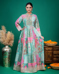 Lower front detail showing the wide embroidered border along the hemline of the sea green printed dress.