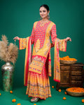 Detail of wide-legged tiered sharara trousers in yellow and coral geometric print.