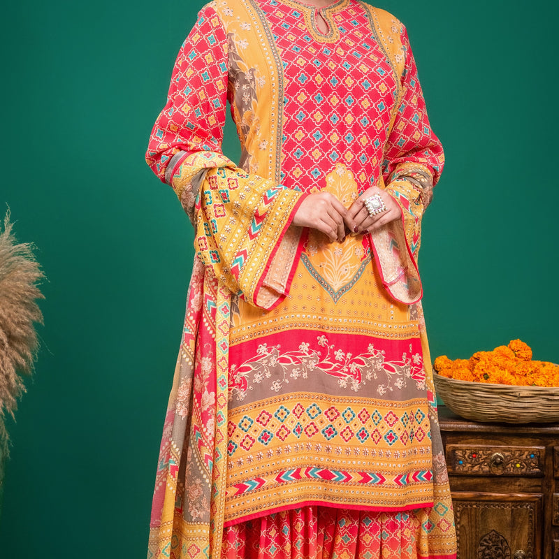 Full ensemble view of coral red and mustard yellow printed Indo-Western sharara dress.