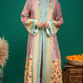 Full length shot of model styled in pink and yellow modal Indo-western dress with green drop earrings
