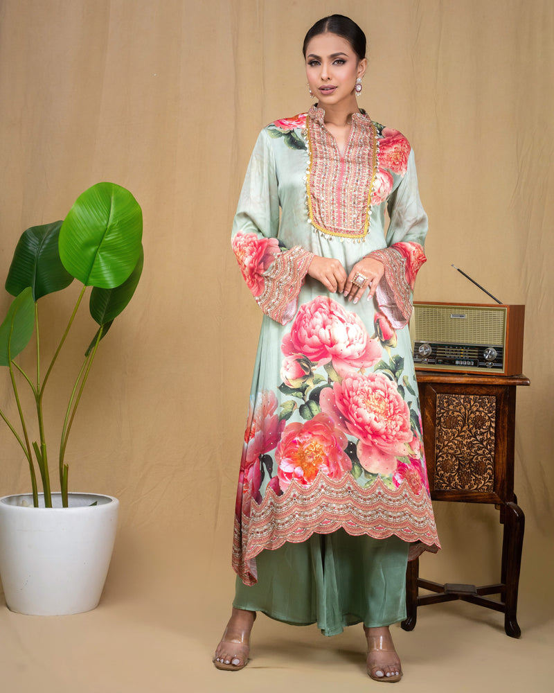 Close-up of hand-embroidered neckline and coin work details on mint green modal dress.