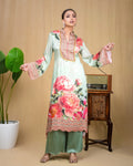 Detailed view of peony floral print and scalloped embroidery on mint modal tunic.