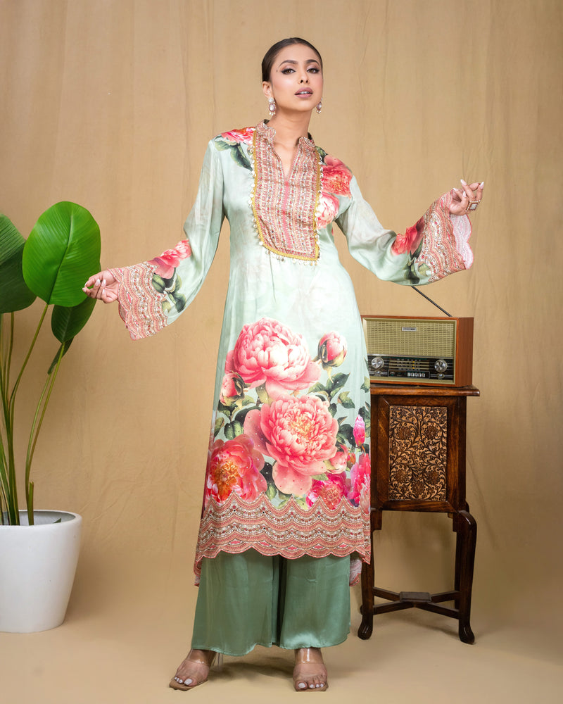 Detailed view of peony floral print and scalloped embroidery on mint modal tunic.