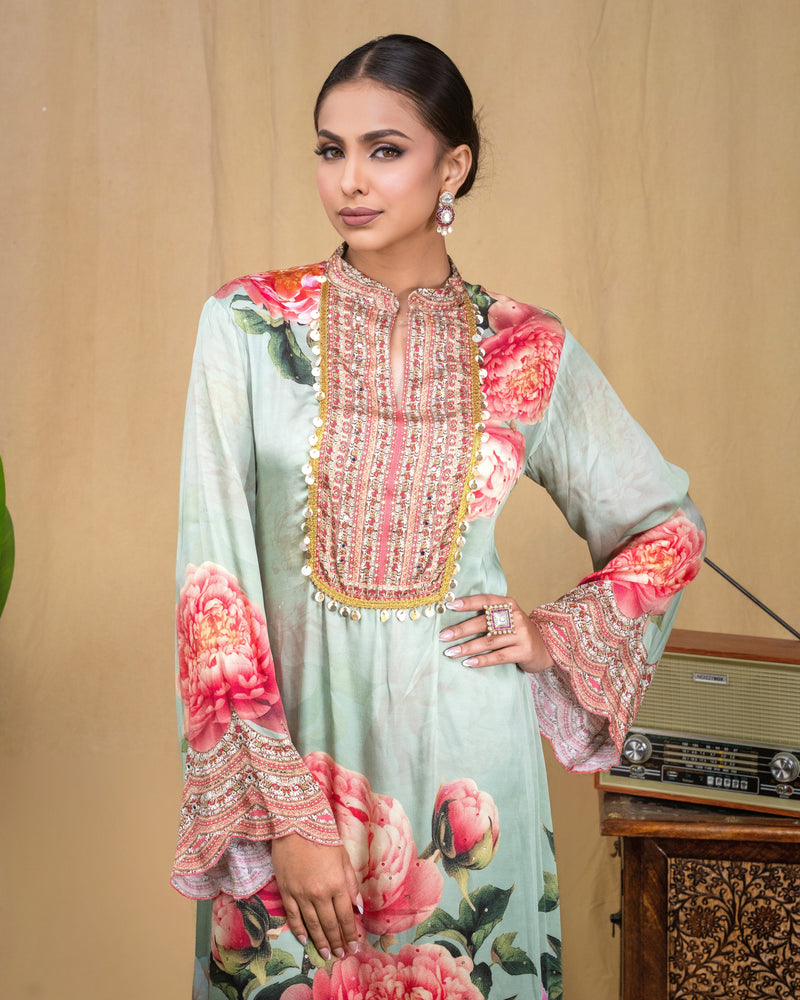 Close-up of intricate scalloped hand embroidery along the hem of mint modal dress.