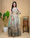Back view of the sage green modal hand embroidered crop top and flowing lehenga skirt set.