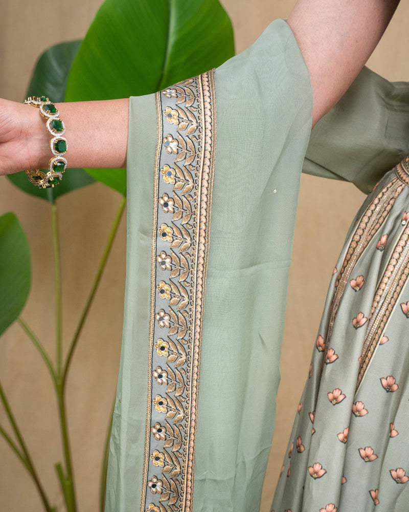 Side profile showing the fit and sleeveless silhouette of the sage green modal lehenga top.