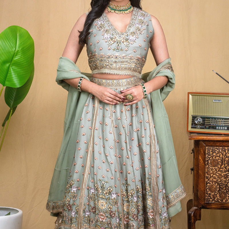 Full view of the sage green modal hand embroidered lehenga set paired with a matching drape.