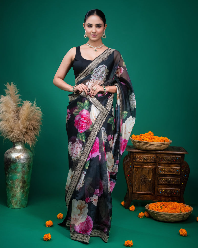 Close-up of a black floral printed organza saree featuring an embroidered zari border