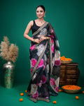 Back view of black organza saree with delicate pink floral print and embellished border
