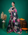 Side profile showing the translucent drape of the black floral organza silk saree