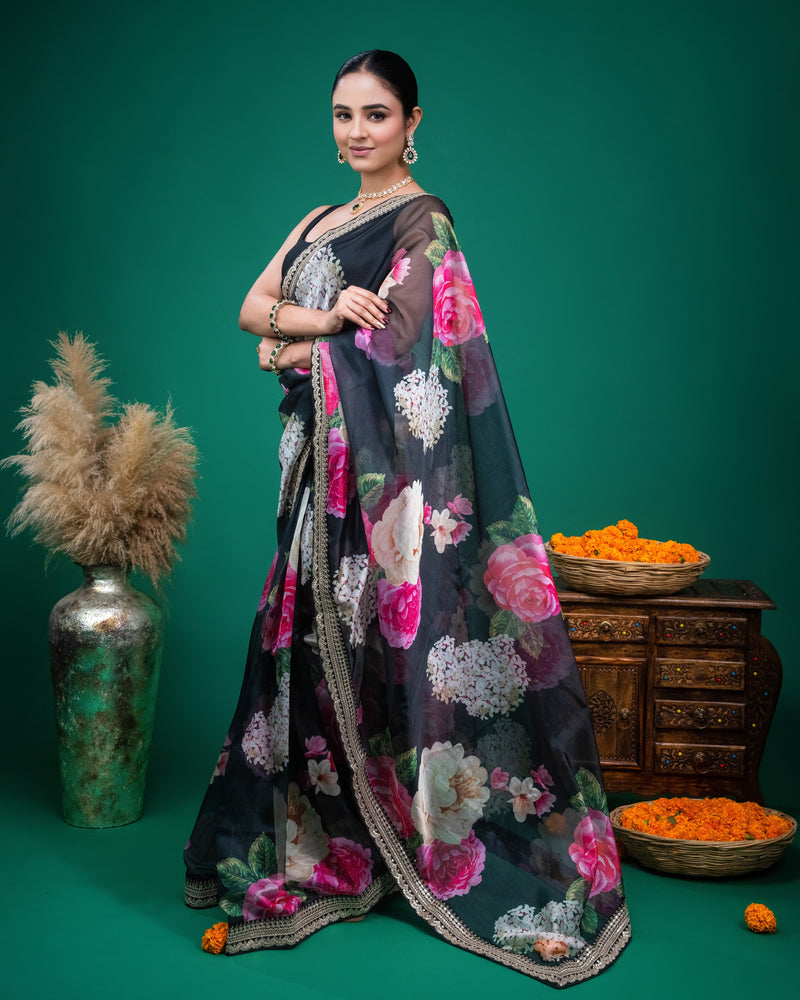 Side profile showing the translucent drape of the black floral organza silk saree
