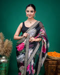 Full length view of a black floral organza saree paired with a sleeveless black blouse