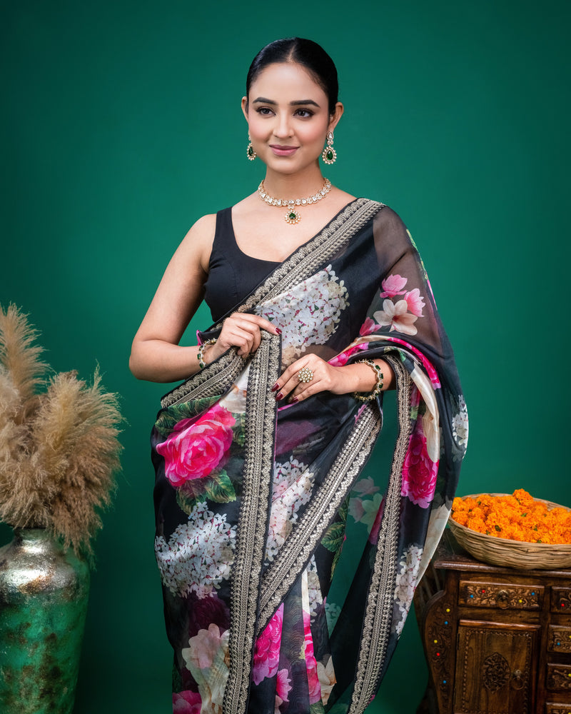 Full length view of a black floral organza saree paired with a sleeveless black blouse