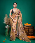 Model styling a light beige organza saree featuring vintage floral print against a green backdrop.
