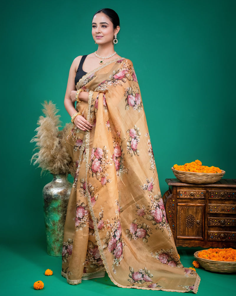 Detailed view of the embroidered scalloped border on a beige floral print organza saree drape.