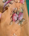 Model wearing a sheer beige floral printed organza saree styled with traditional jewelry.