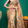 Elegant drape view of a beige organza floral saree with gold scalloped lace edging.