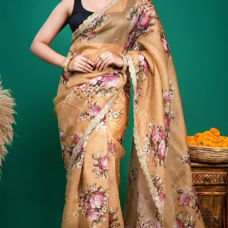 Elegant drape view of a beige organza floral saree with gold scalloped lace edging.